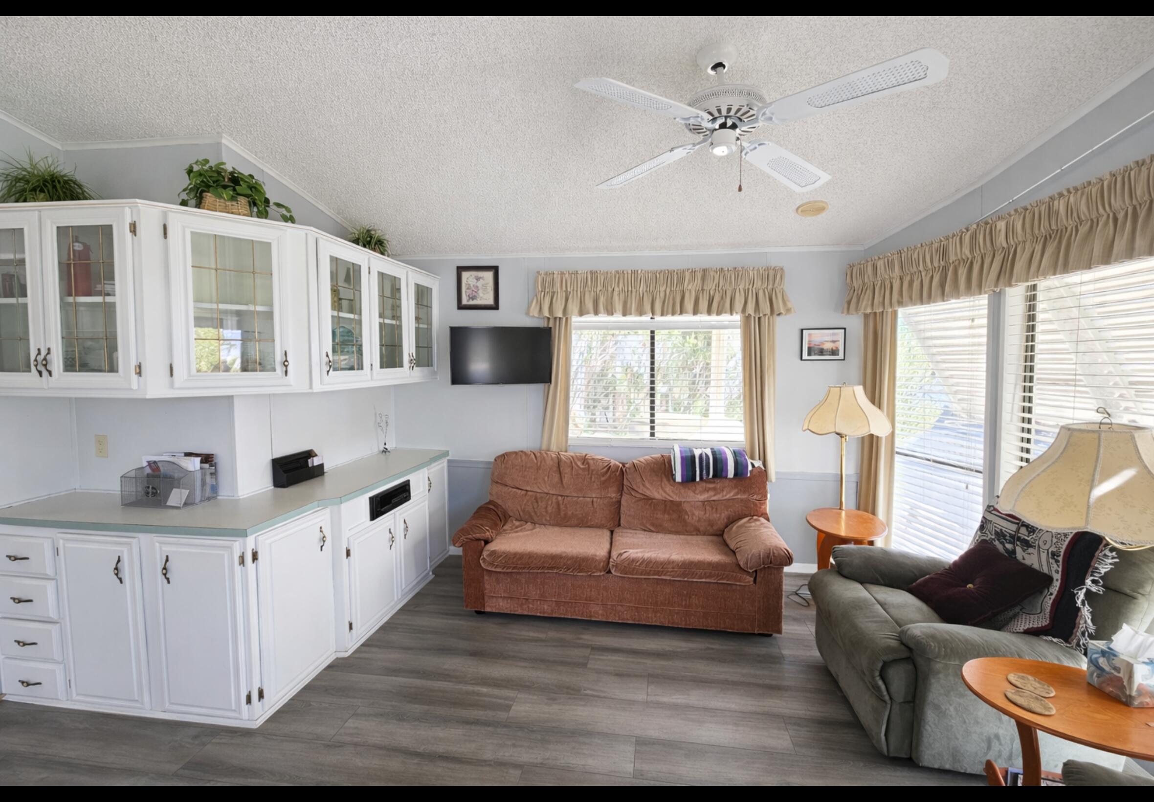 16400 Bubbling Wells Road, Unit 95 Desert Hot Springs, CA 92240 - Photo 3 of 21 a living room with furniture and a chandelier
