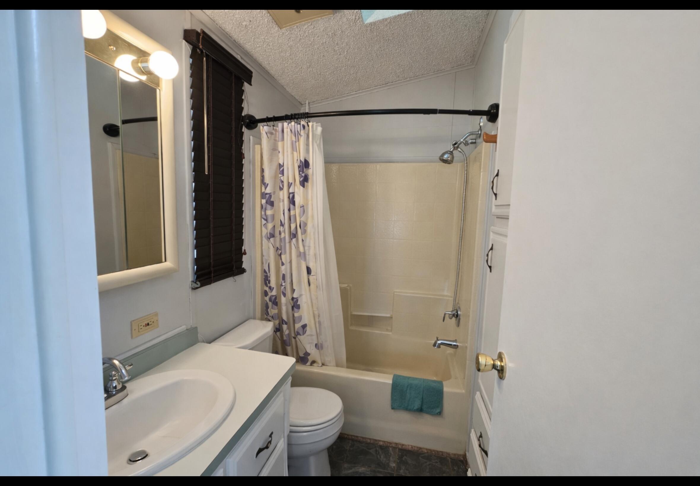 16400 Bubbling Wells Road, Unit 95 Desert Hot Springs, CA 92240 - Photo 7 of 21 a bathroom with a sink toilet and shower