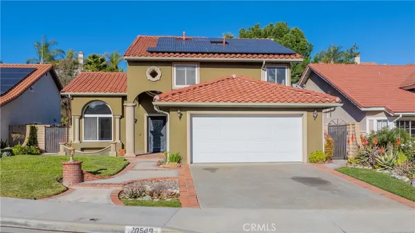 a front view of a house with yard