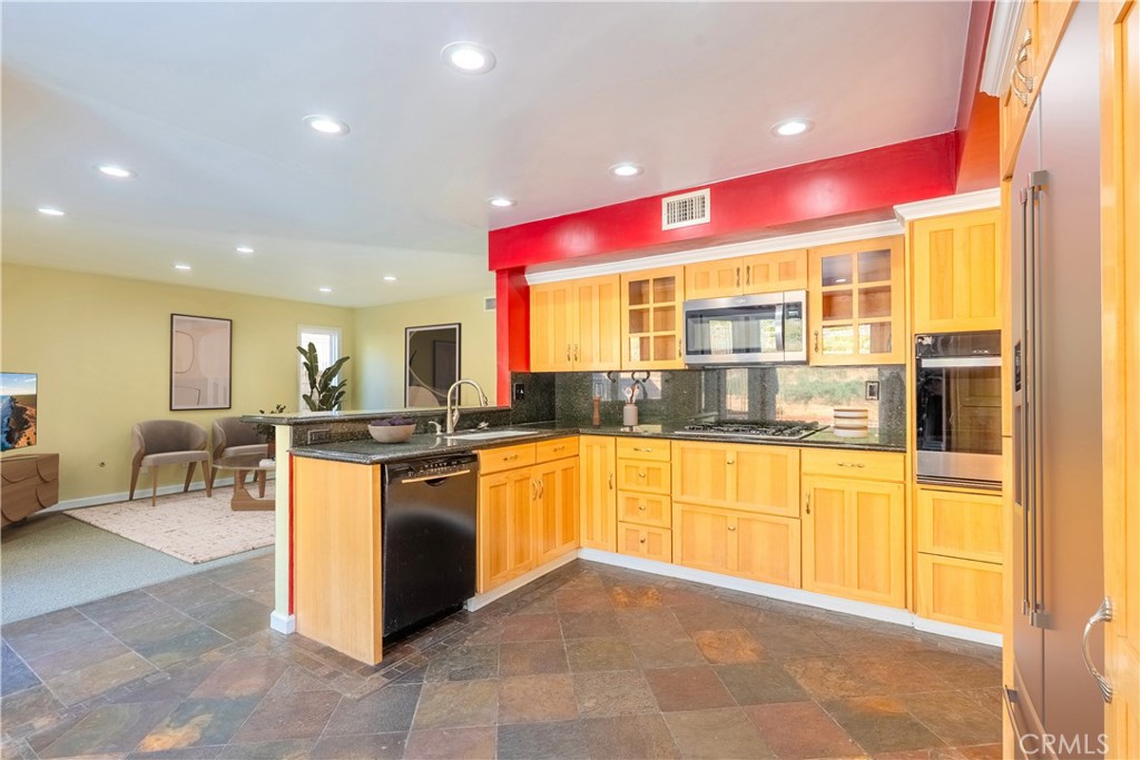 20549 Romar Lane Saugus, CA 91350 - Photo 11 of 31 a kitchen with stainless steel appliances granite countertop a stove and cabinets