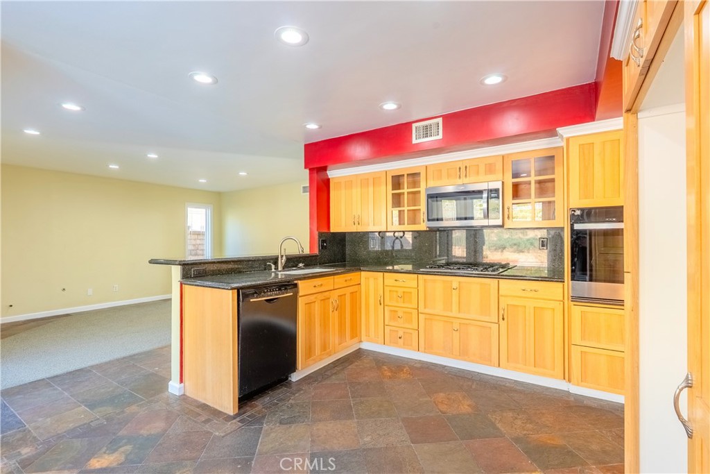 20549 Romar Lane Saugus, CA 91350 - Photo 12 of 31 a large kitchen with stainless steel appliances granite countertop a barbecue grill and granite counter top