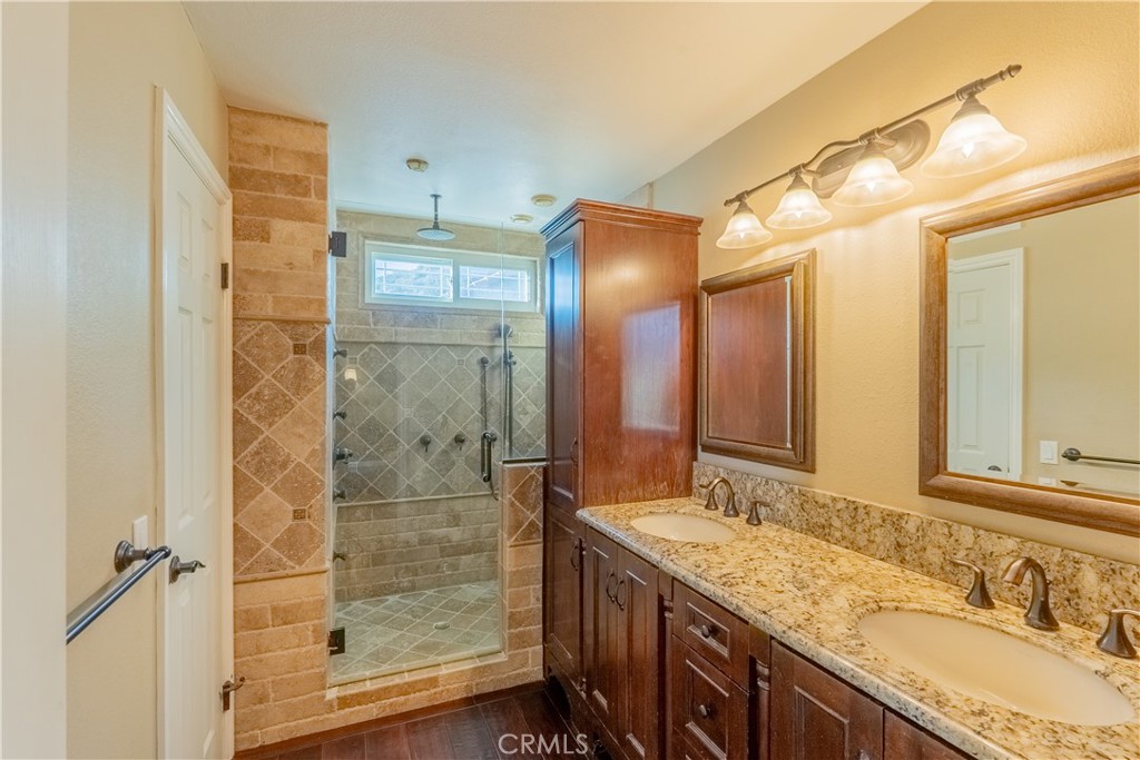 20549 Romar Lane Saugus, CA 91350 - Photo 21 of 31 a bathroom with a granite countertop sink mirror and double