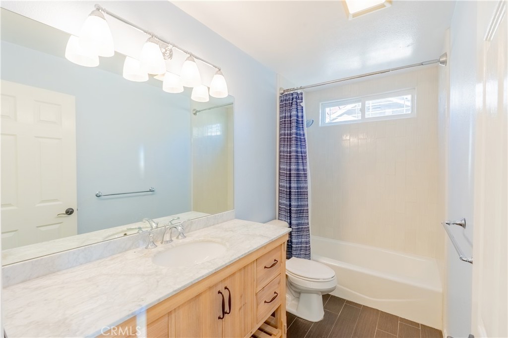 20549 Romar Lane Saugus, CA 91350 - Photo 29 of 31 a bathroom with a granite countertop sink a toilet a mirror and shower