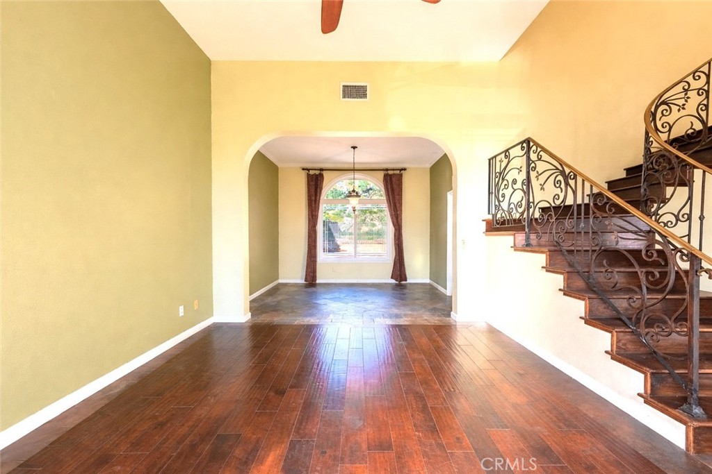 20549 Romar Lane Saugus, CA 91350 - Photo 8 of 31 a hallway with wooden floor windows and a chandelier