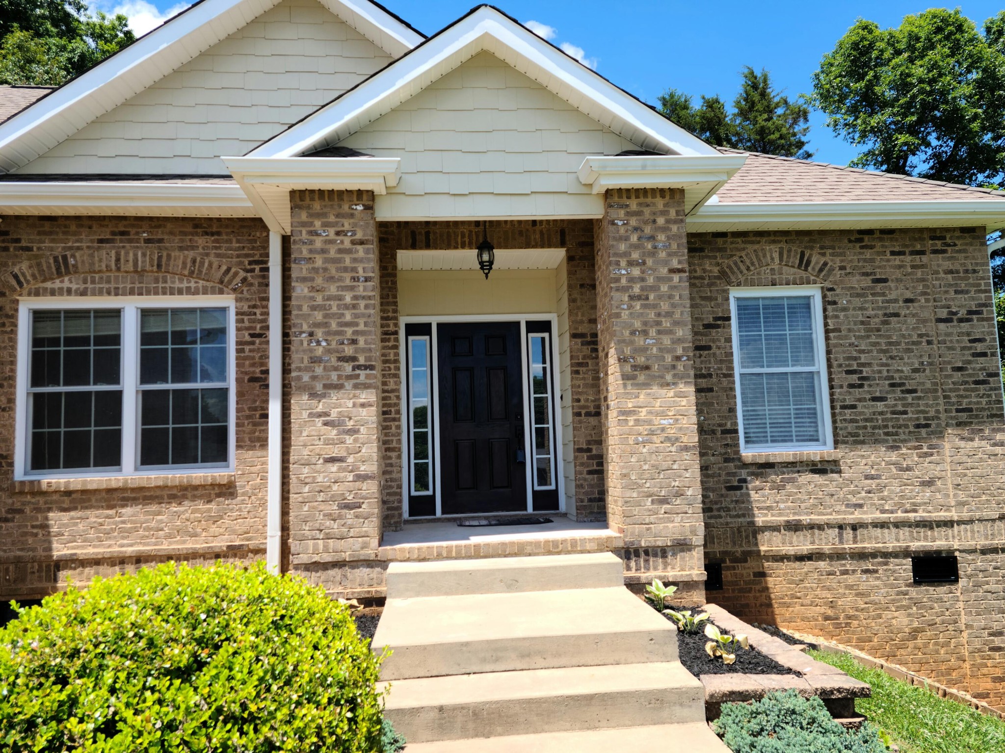 6092 Whisper Ridge Lane Corryton, TN 37721 - Photo 1 of 17 a front view of a house with a yard