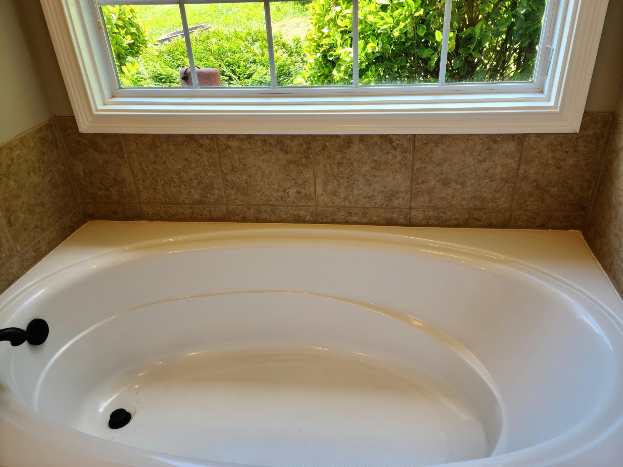 6092 Whisper Ridge Lane Corryton, TN 37721 - Photo 13 of 17 a close up of a bathtub in a bathroom