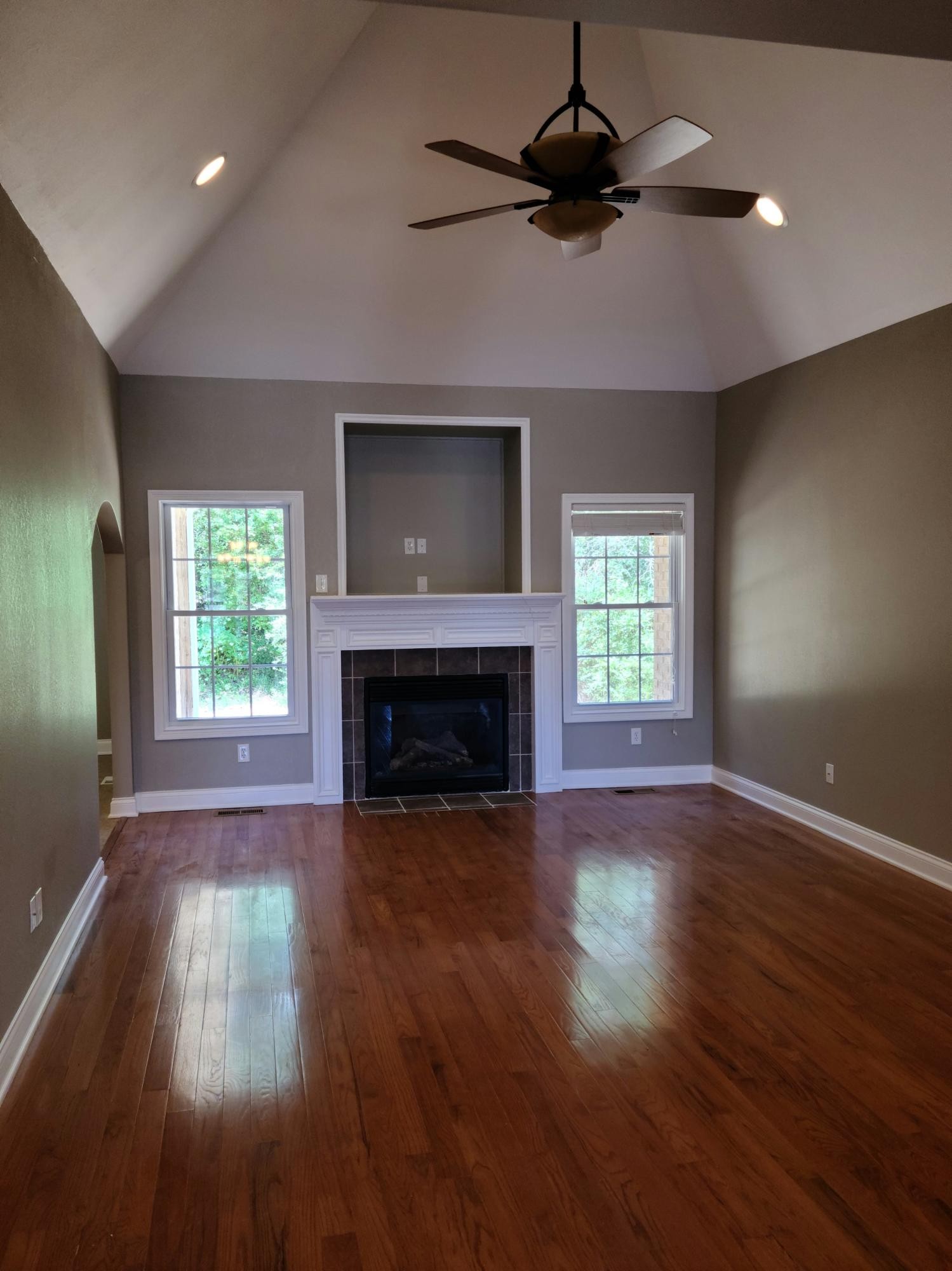 6092 Whisper Ridge Lane Corryton, TN 37721 - Photo 4 of 17 an empty room with wooden floor fireplace and windows