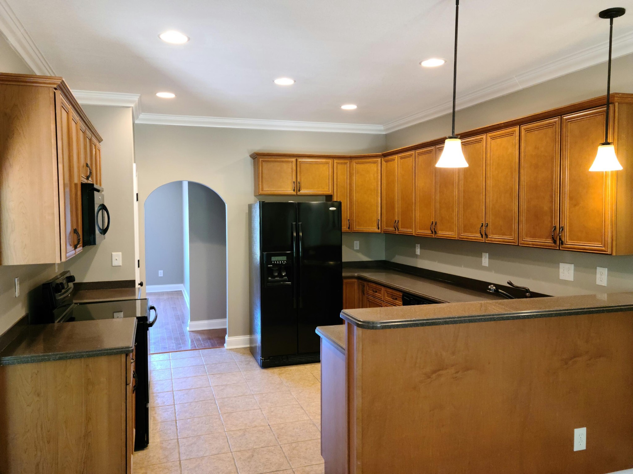 6092 Whisper Ridge Lane Corryton, TN 37721 - Photo 6 of 17 a kitchen with stainless steel appliances granite countertop a refrigerator a sink and a stove