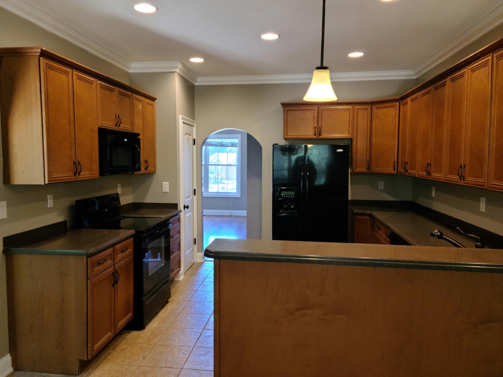 6092 Whisper Ridge Lane Corryton, TN 37721 - Photo 7 of 17 a kitchen with stainless steel appliances granite countertop a refrigerator a stove and a microwave