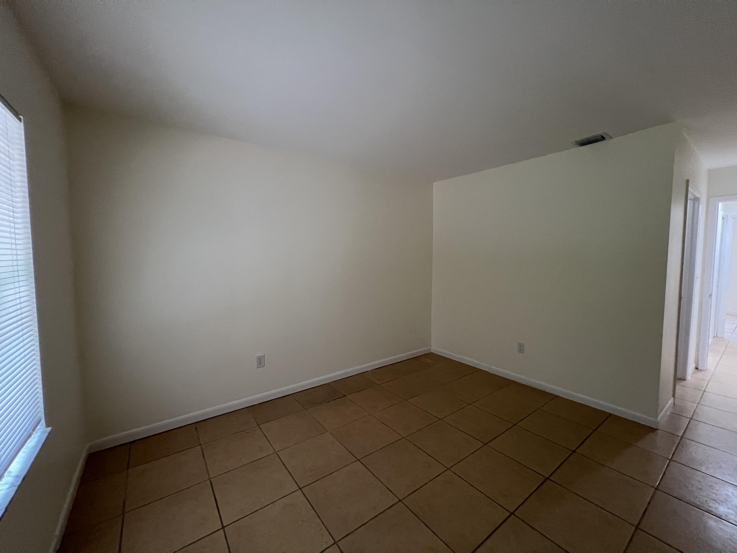 17345 Bush Road, Unit D Jupiter, FL 33458 - Photo 16 of 27 an empty room with a bench