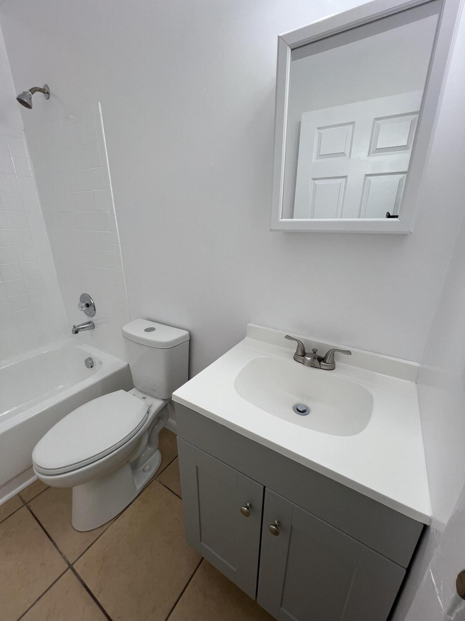 17345 Bush Road, Unit D Jupiter, FL 33458 - Photo 22 of 27 a bathroom with a sink toilet and shower