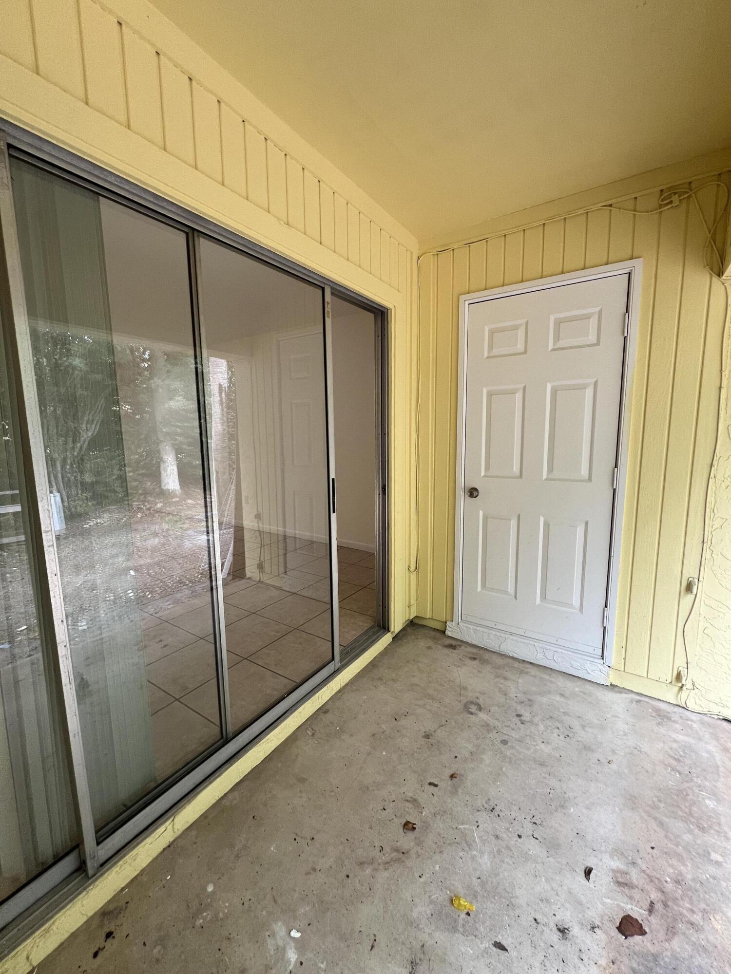 17345 Bush Road, Unit D Jupiter, FL 33458 - Photo 27 of 27 an empty room with sliding door