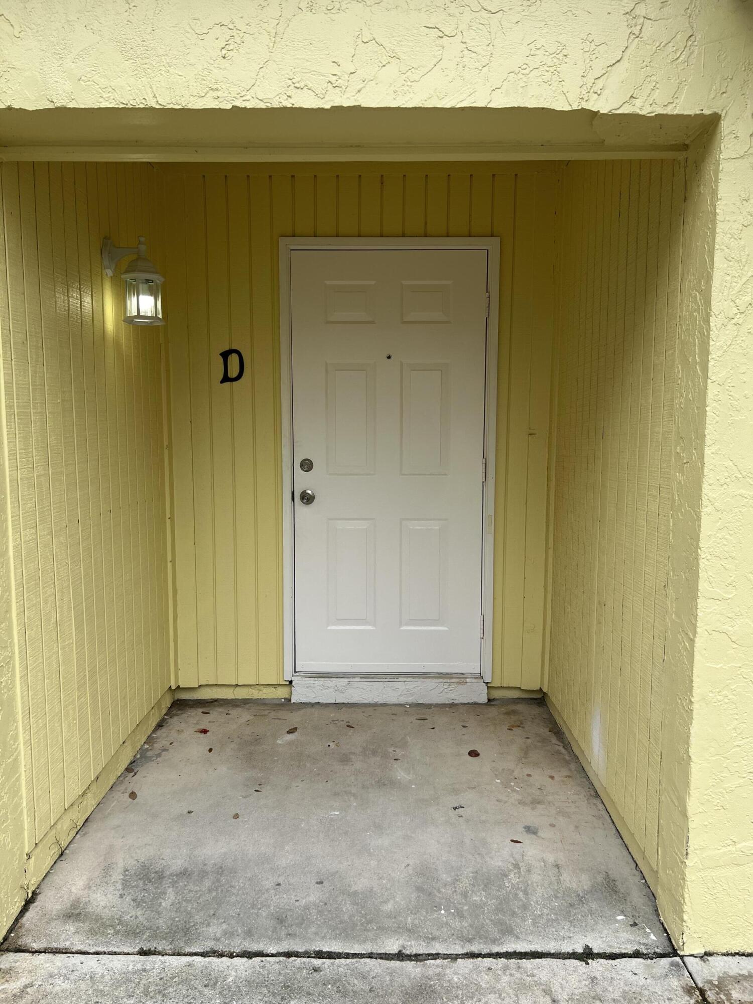 17345 Bush Road, Unit D Jupiter, FL 33458 - Photo 4 of 27 an empty room with a wooden door