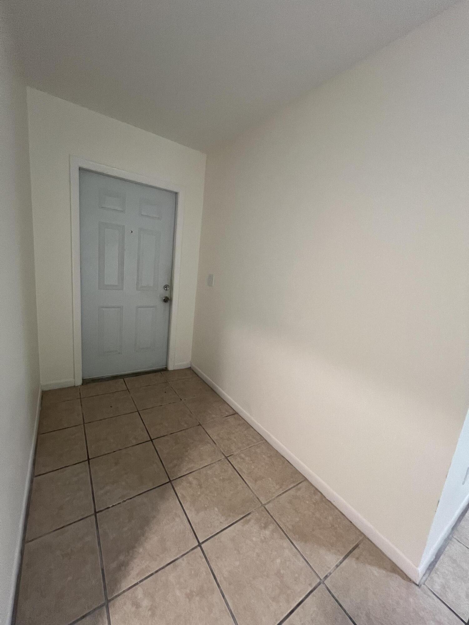 17345 Bush Road, Unit D Jupiter, FL 33458 - Photo 5 of 27 a view of an empty room and chandelier