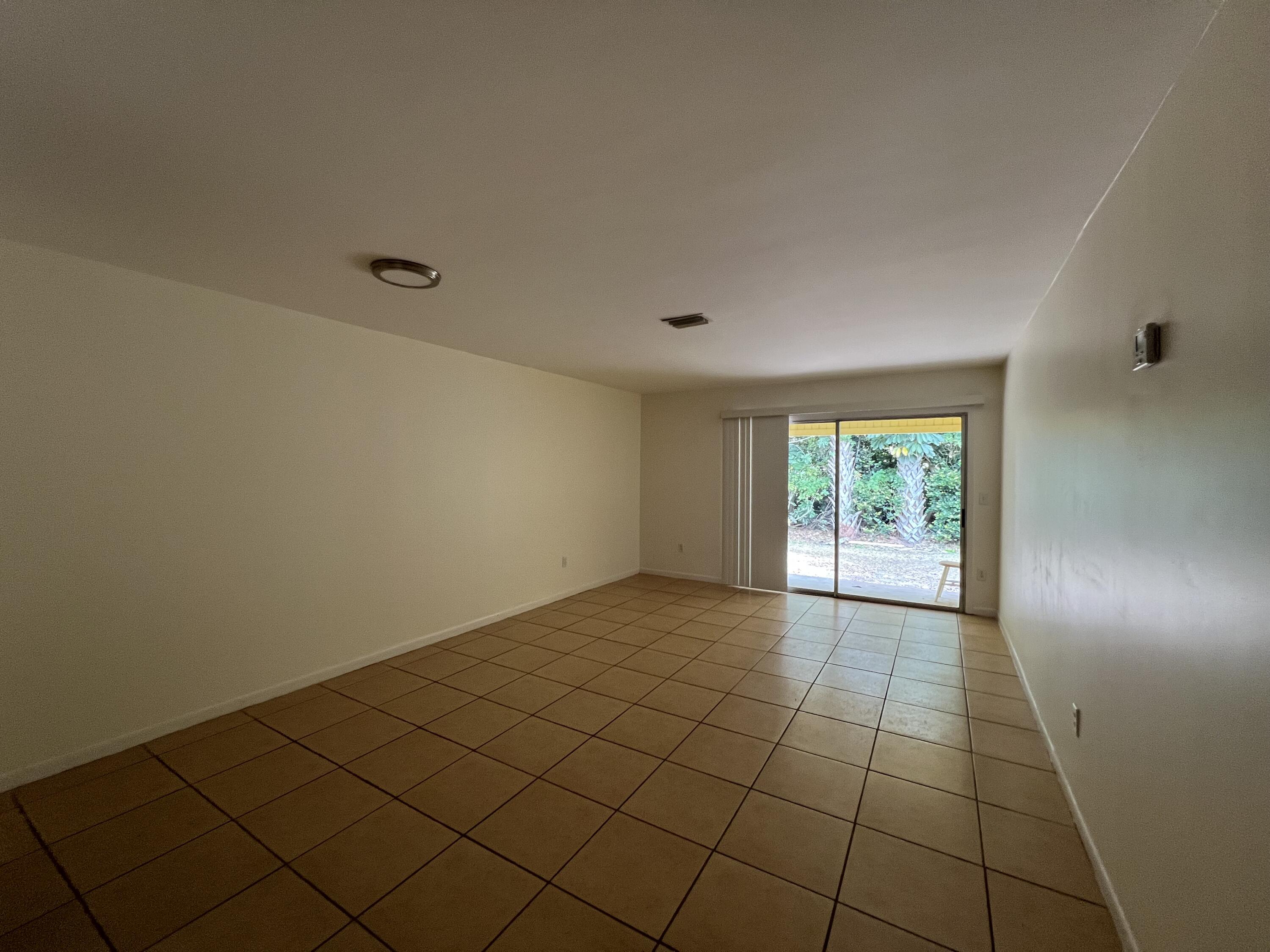 17345 Bush Road, Unit D Jupiter, FL 33458 - Photo 7 of 27 a view of an empty room and window