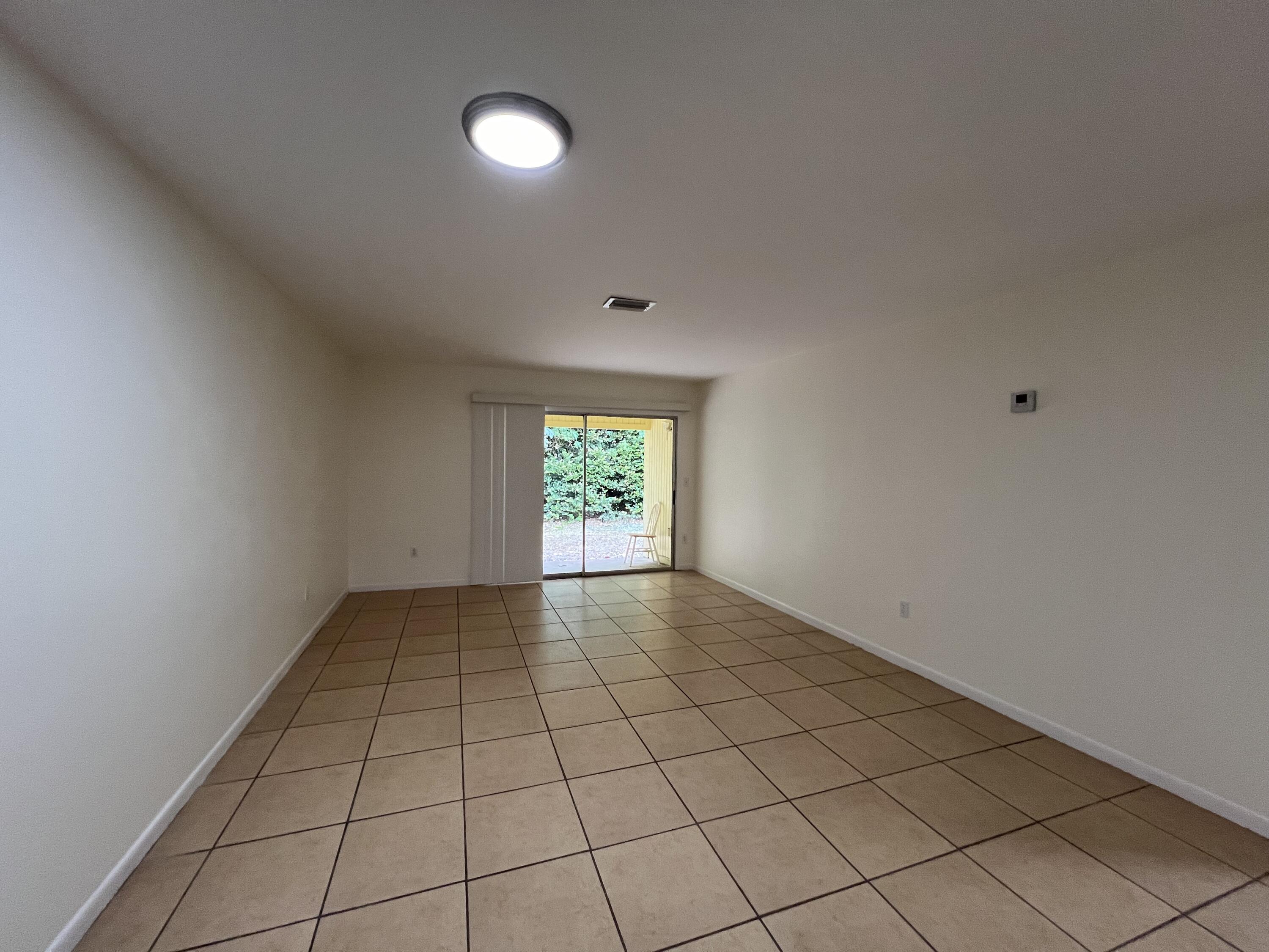 17345 Bush Road, Unit D Jupiter, FL 33458 - Photo 9 of 27 a view of an empty room and window
