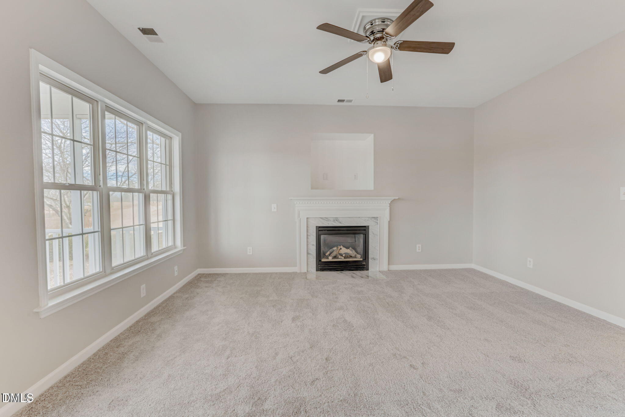 480 Seastone Street Raleigh, NC 27603 - Photo 13 of 26 a view of an empty room with chandelier fan and fire place