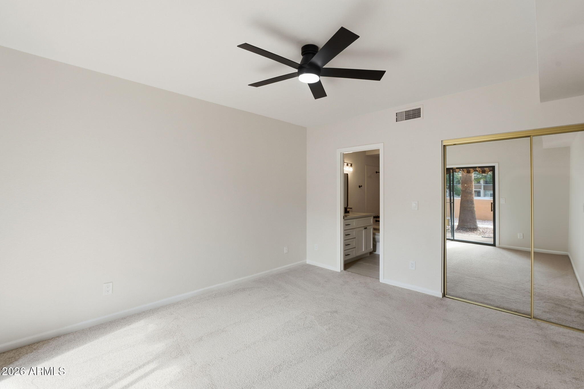 5640 East Bell Road Scottsdale, AZ 85254 - Photo 18 of 26 a view of a livingroom with a ceiling fan and wooden floor
