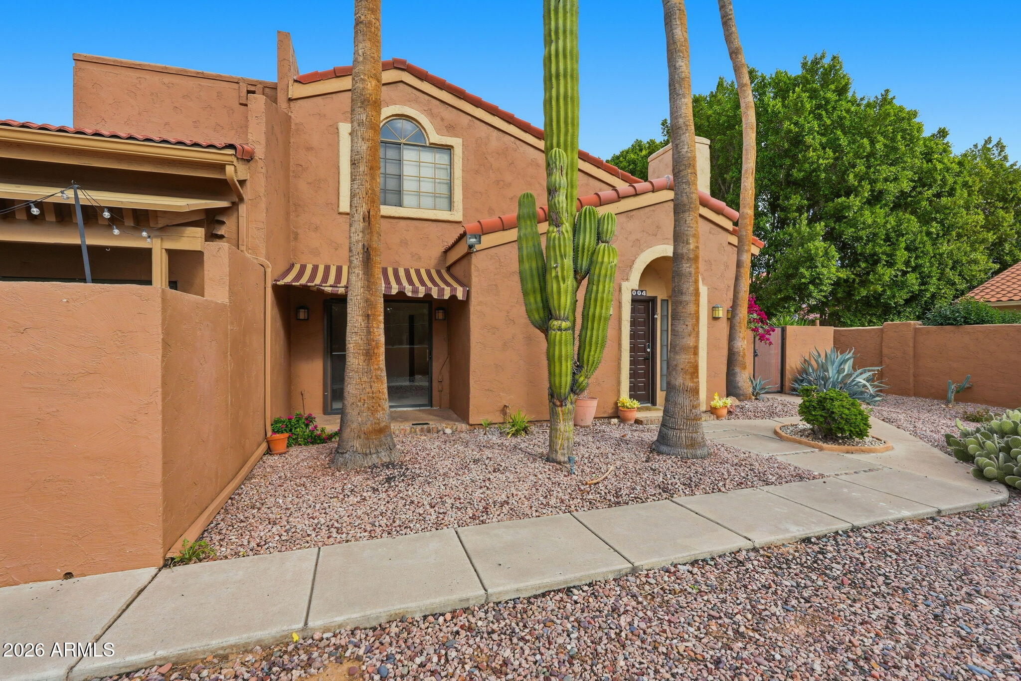 5640 East Bell Road Scottsdale, AZ 85254 - Photo 2 of 26 a front view of a house with a yard