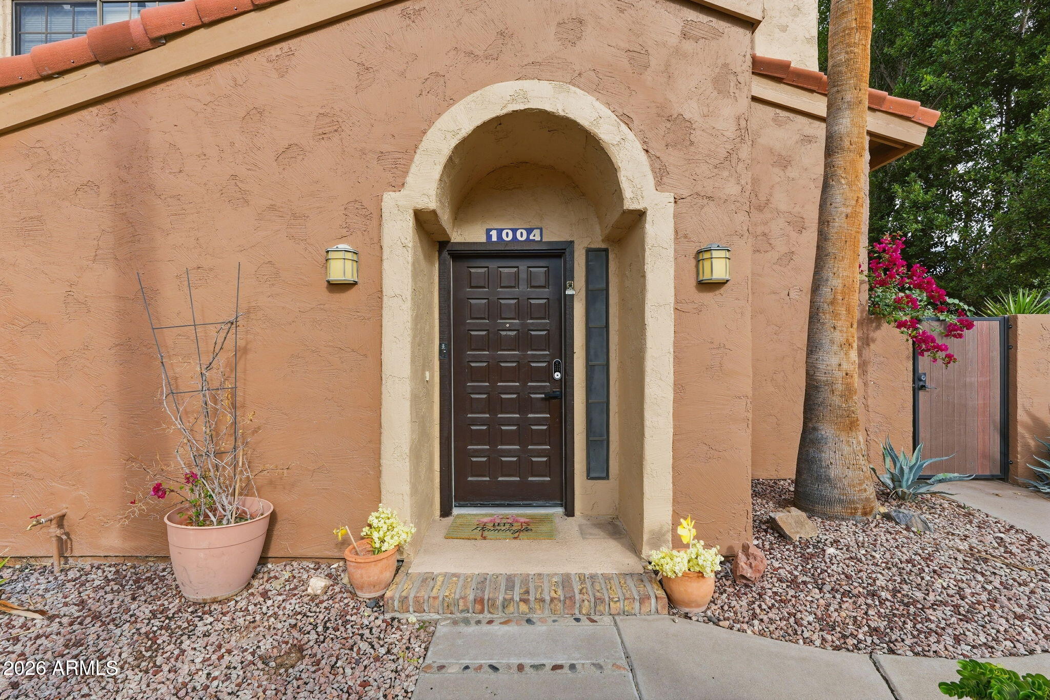 5640 East Bell Road Scottsdale, AZ 85254 - Photo 3 of 26 a view of a door of the house with potted plants