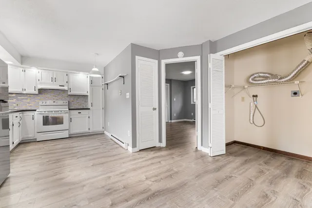 a view of a kitchen with a sink and wooden floor