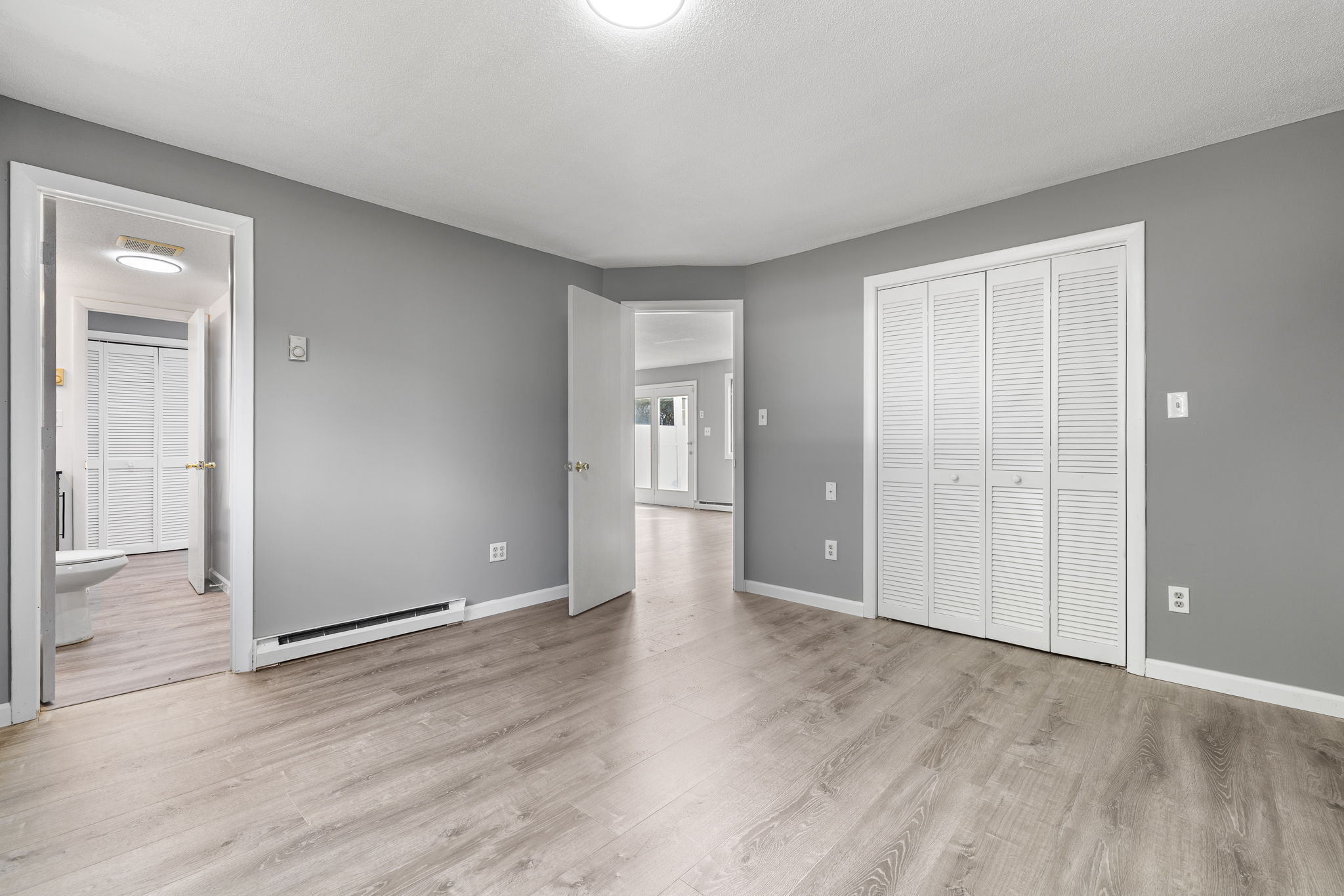 8 Burma Road Southbury, CT 06488 - Photo 17 of 23 an empty room with wooden floor & windows and bathroom