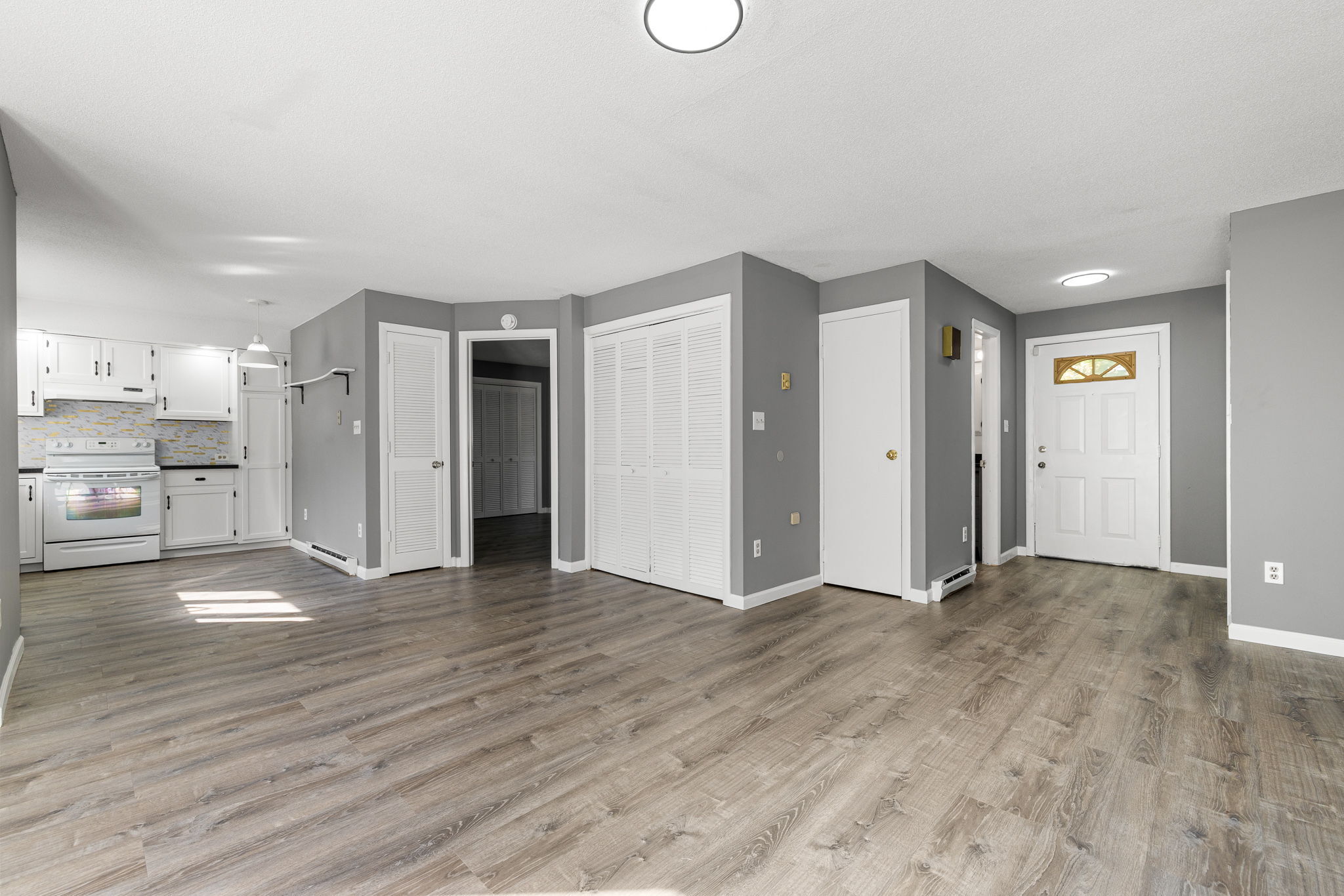 8 Burma Road Southbury, CT 06488 - Photo 2 of 23 a view of an empty room with wooden floor and a kitchen