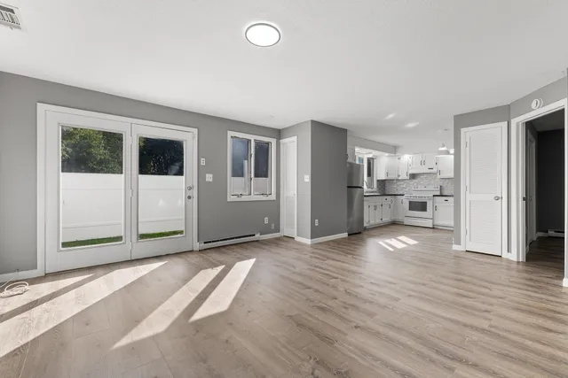 a view of a kitchen with refrigerator and window