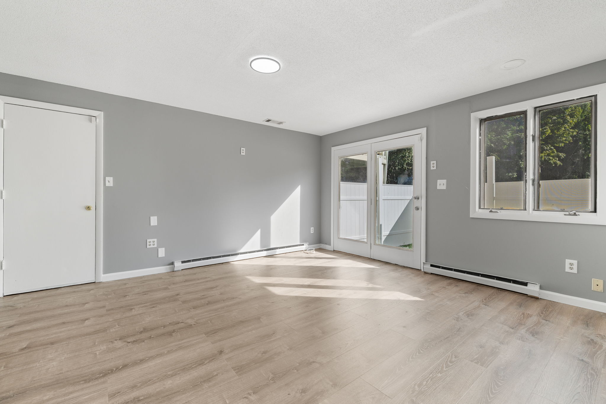 8 Burma Road Southbury, CT 06488 - Photo 5 of 23 a view of an empty room with wooden floor and a window