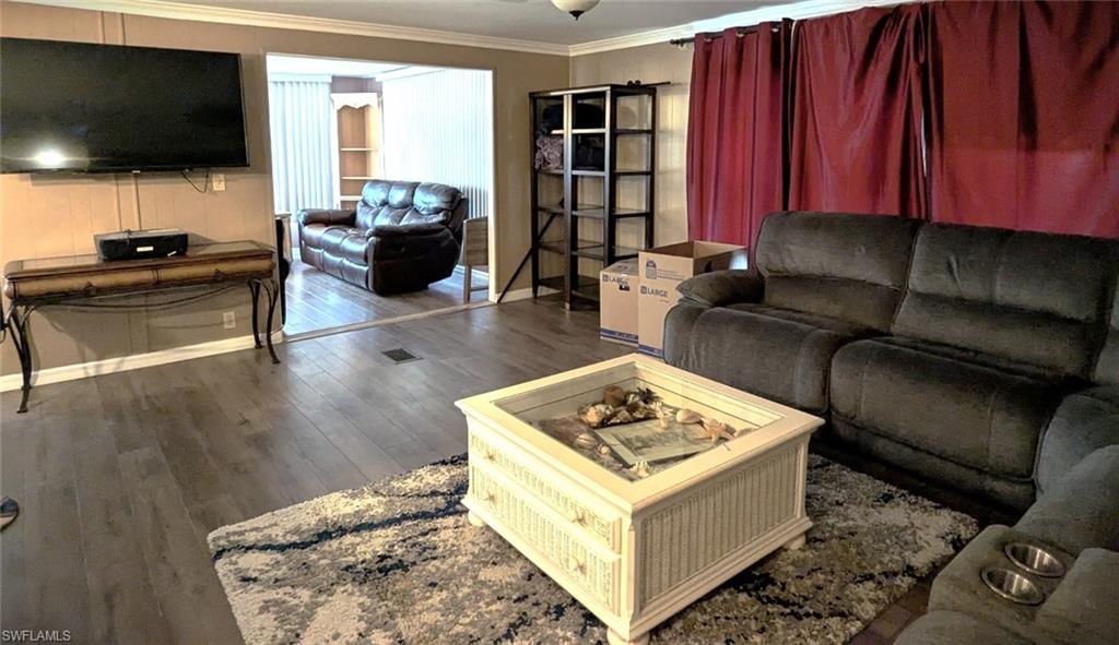9269 Lord Road Bonita Springs, FL 34135 - Photo 13 of 20 a living room with furniture and a flat screen tv