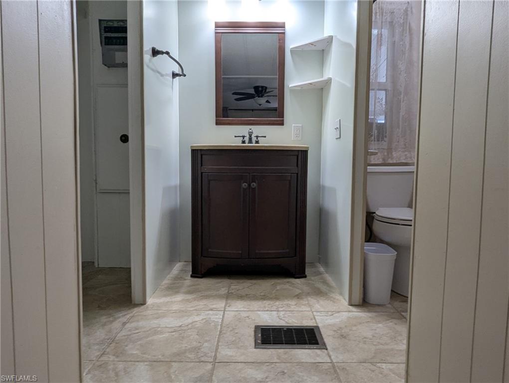 9269 Lord Road Bonita Springs, FL 34135 - Photo 14 of 20 a bathroom with a sink and a mirror