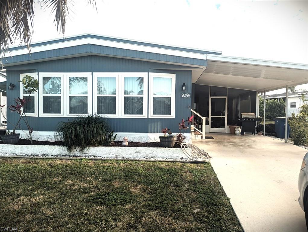 9269 Lord Road Bonita Springs, FL 34135 - Photo 3 of 20 a front view of a house with a yard