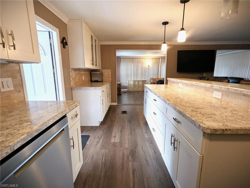 9269 Lord Road Bonita Springs, FL 34135 - Photo 8 of 20 a large kitchen with granite countertop a lot of counter space and wooden floor