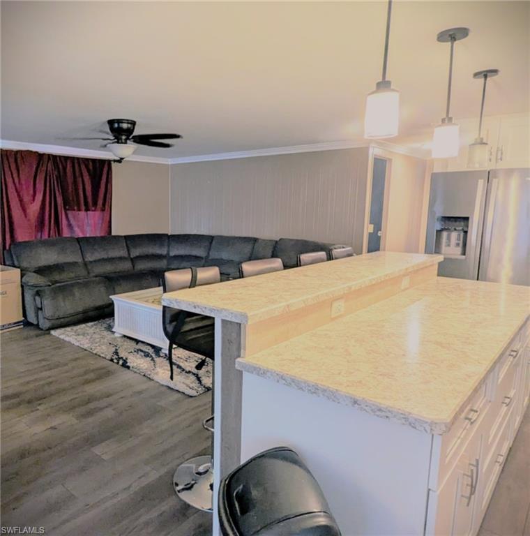 9269 Lord Road Bonita Springs, FL 34135 - Photo 20 of 20 a bedroom with a bed and a chandelier