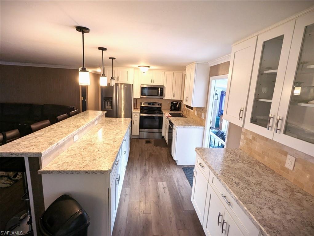 9269 Lord Road Bonita Springs, FL 34135 - Photo 9 of 20 a kitchen with sink refrigerator and wooden floor