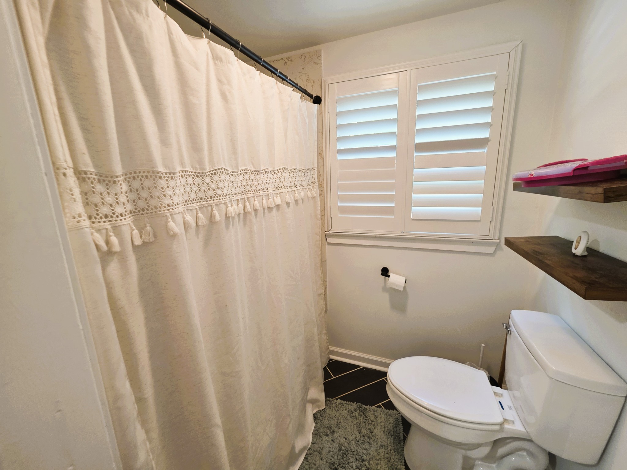 1975 Kelly Road Holladay, TN 38341 - Photo 55 of 95 a white toilet sitting next to a shower curtain