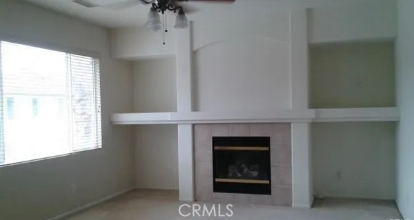 a living room with a fireplace and a window