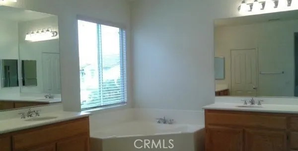 a bathroom with a sink double vanity and a bathtub