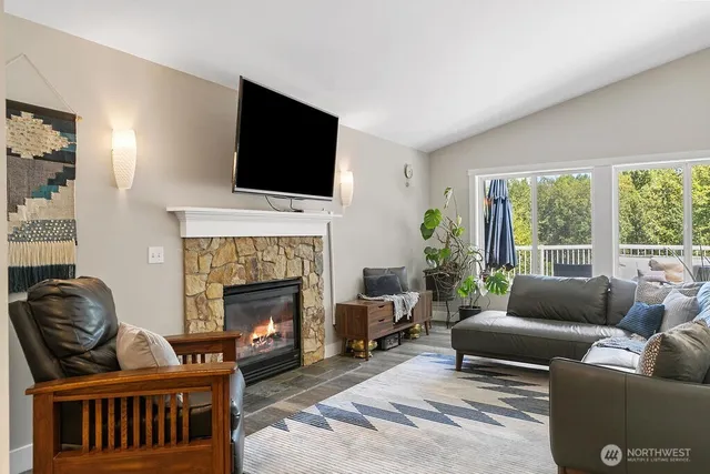 a living room with furniture fireplace and flat screen tv