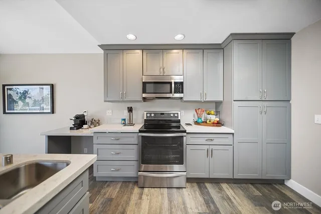 a kitchen with a sink stove and refrigerator