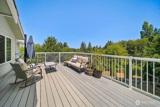 a view of a balcony with two chairs and wooden floor