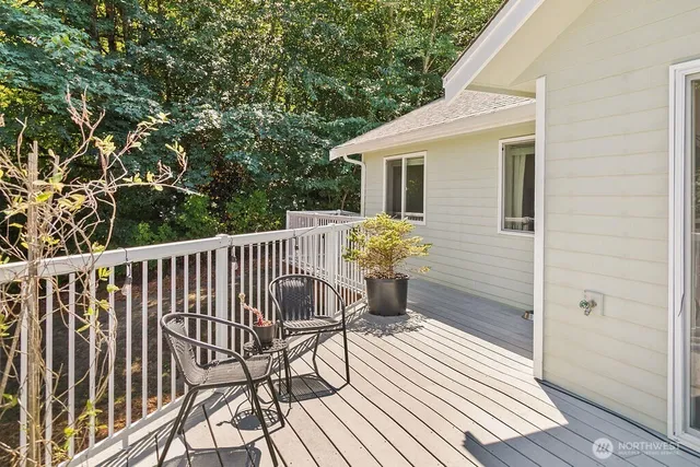 a view of balcony with wooden floor and seating space