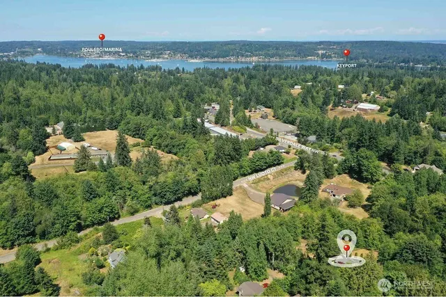 an aerial view of a house with a yard