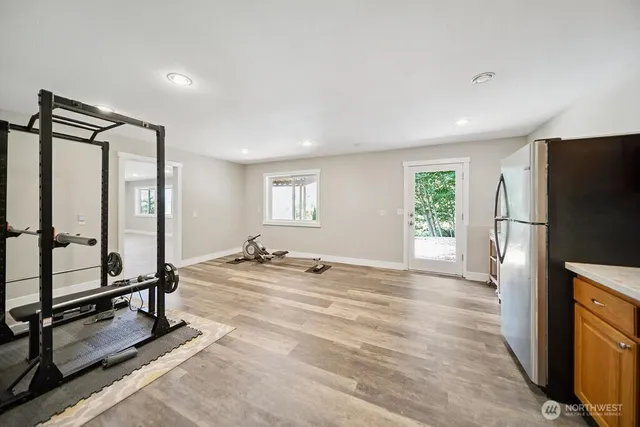 a view of a room with gym equipment and a window