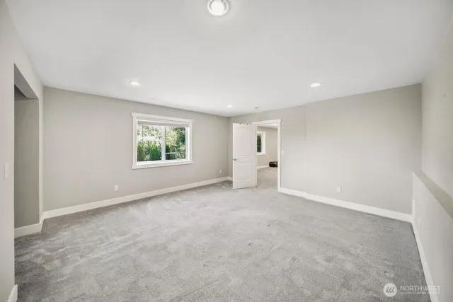 an empty room with windows and entrance