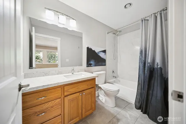 a spacious bathroom with a toilet sink and mirror