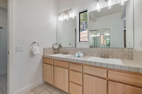 a bathroom with a double vanity sink and mirror