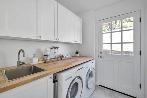 a utility room with sink dryer and washer