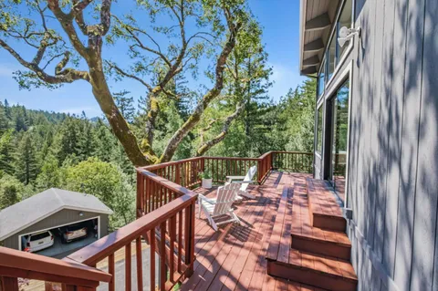 a view of balcony with wooden floor and fence