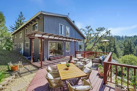 a view of a patio with table and chairs and wooden floor